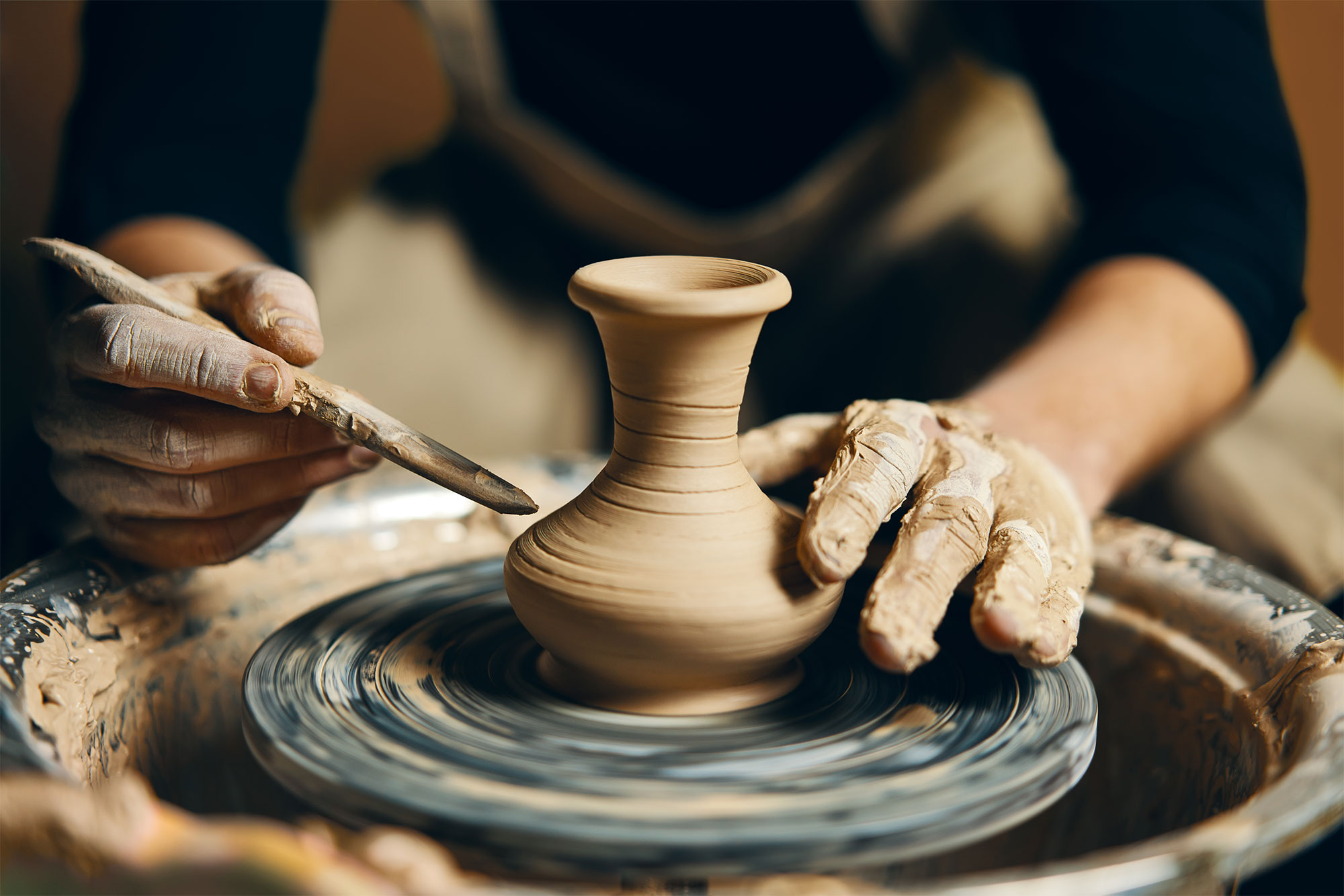 Keramikerin an einer Drehscheibe