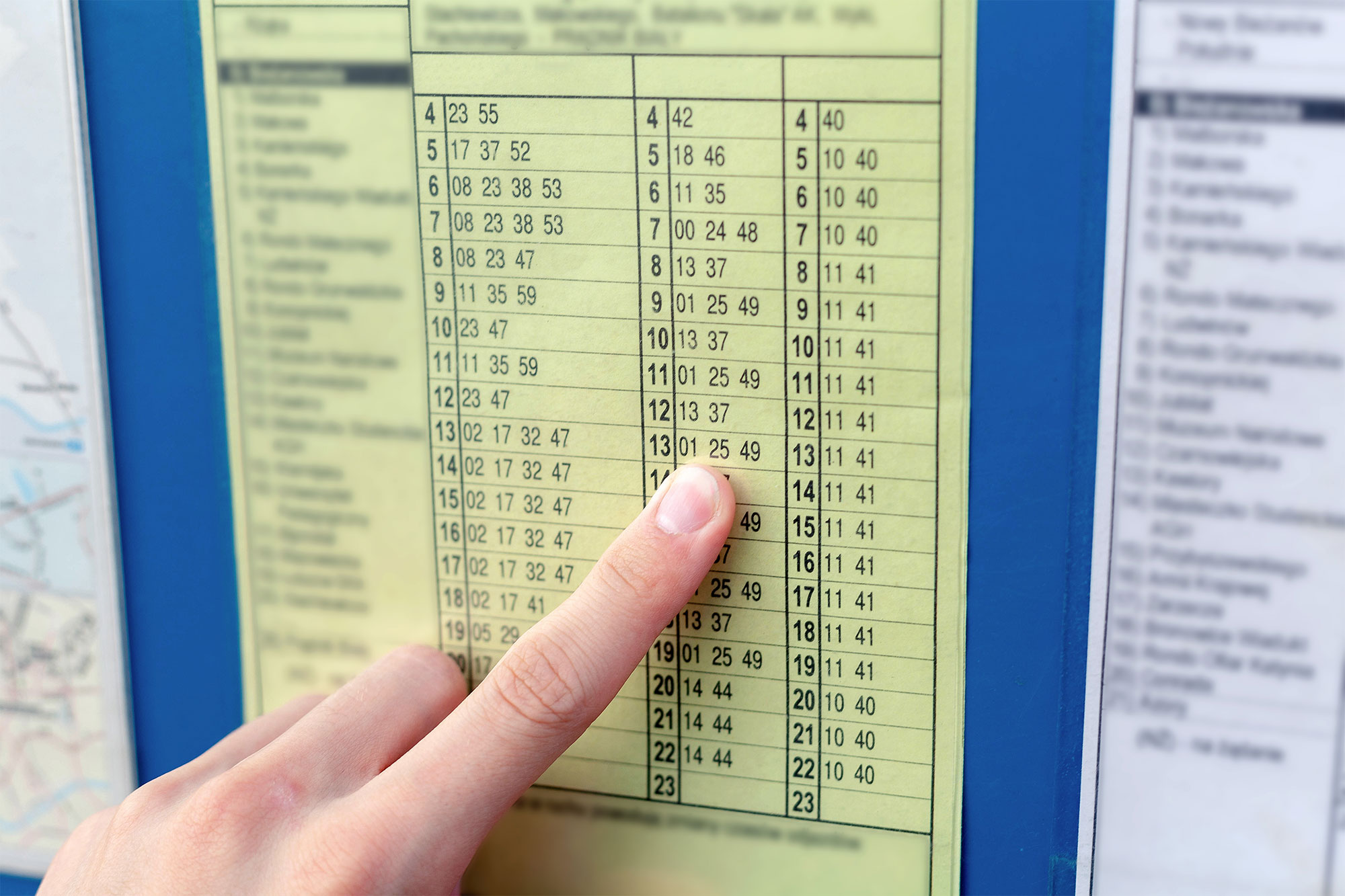 Finger zeigt auf Busfahrplan